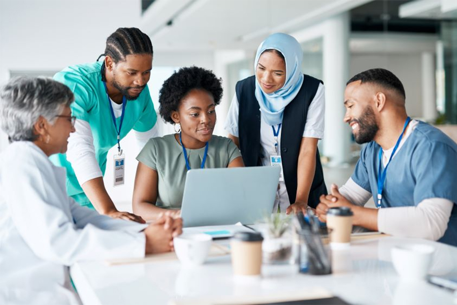 Health workers gathered around a computer