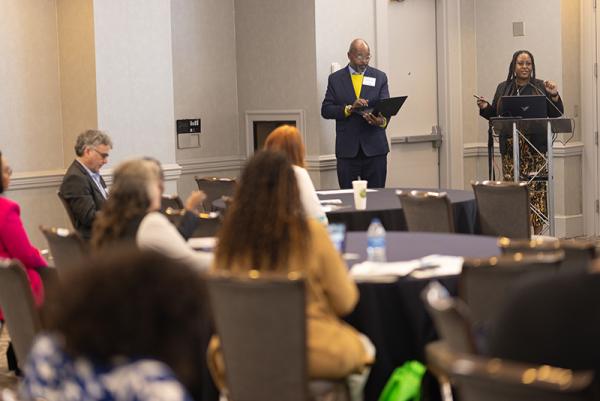 People listening to a speaker at a conference